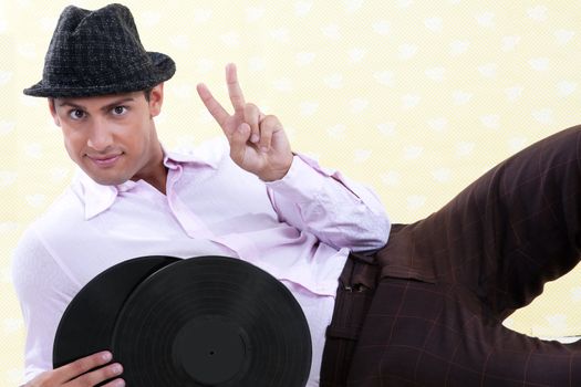 Man holding vinyl record making victory sign.