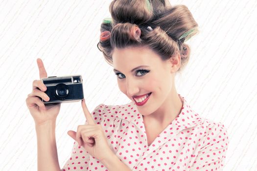 Retro styled woman holding old 35mm film camera