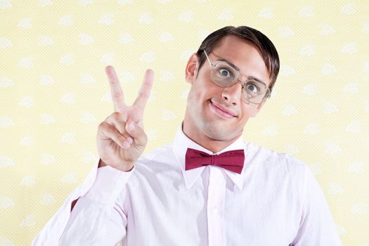 Portrait of a geek styled man giving peace sign