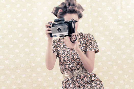 Woman taking photograph from vintage 4x6 film camera .