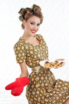 Retro woman with cookies looking at camera with smile.