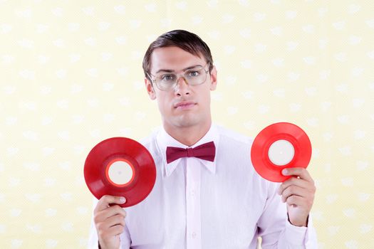 Retro style man holding vinyl record .