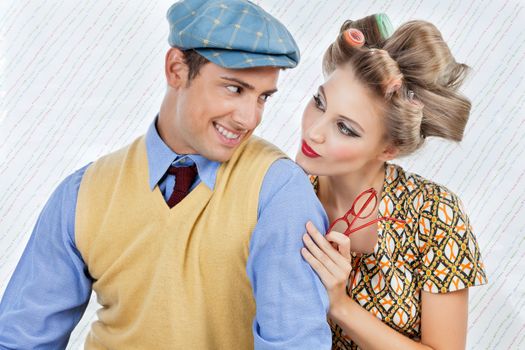 Retro styled young couple looking at each other over textured background