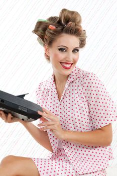 Portrait of attractive retro styled woman with cassette player