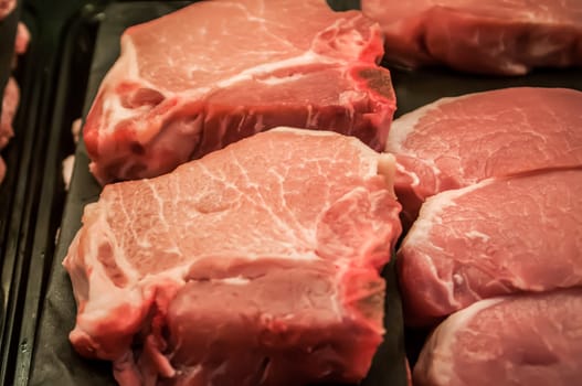 fresh raw pork chops at the butcher