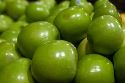 green apples on display at farmers market