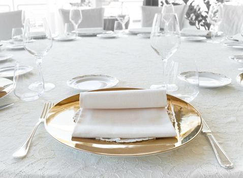 Wedding catering setting with plate and cutlery disposition on the table