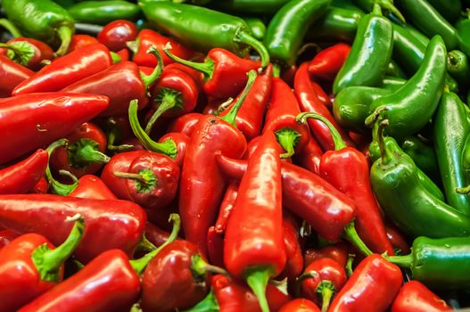 Delicious fresh green and red chili fruit on display at supermarket