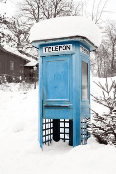 Blue Telephone Booth with snow in Stockholm Sweden