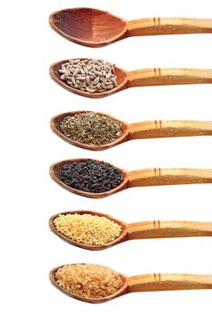 collection of ingredients in wooden spoons isolated over white background