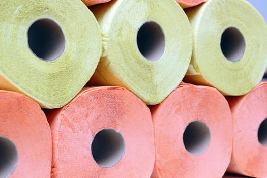 stack of yellow and pink recycled toilet paper