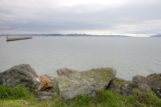 Scenic HDR image of rocky coastline near the Berkely Marina in the San Francisco Bay.  Golden Gate Bridge in  background