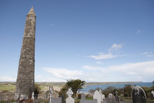 Ancient round tower and celtic graveyard with cathedral in Ardmore county Waterford, Ireland