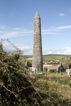 Ancient round tower and celtic graveyard with cathedral in Ardmore county Waterford, Ireland