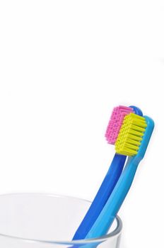 Colorful toothbrushes in a glass