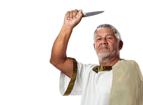 A senior man dressed in emperor's clothes clasps a knife in his hand.