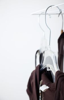 Close-up photo of the brown clothes and hangers in the dressing room