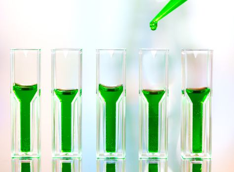 Spectrophotometer quvettes on a reflective surface, copy space