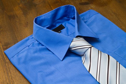 New blue man's shirt and tie isolated on wood