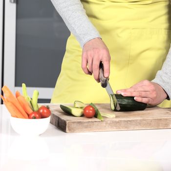 Woman cutting vegetables at home