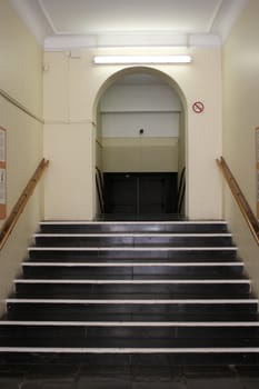 Staircase going up to a corridor with no people