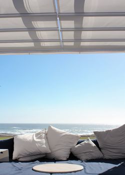 Beach club couch with ocean in the background