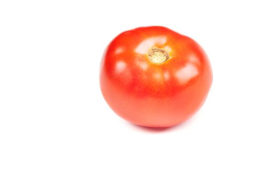 Red tomato on a white background. Color photo