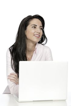 Beautiful young woman sat at white table with her laptop computer