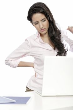 Beautiful young woman with back pain at her office desk