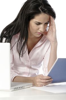 Woman studying a business document whilst rubbing her head