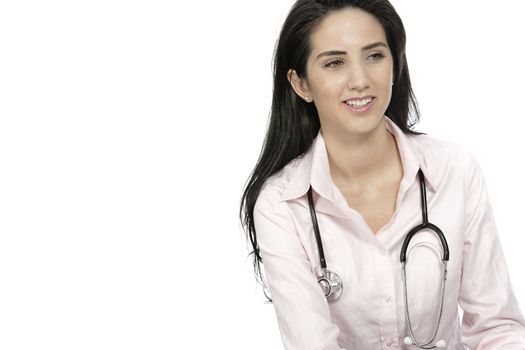 Beautiful young doctor sat smiling at her work desk