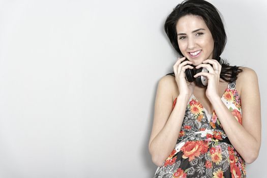 Attractive young woman using headphones to listen to music