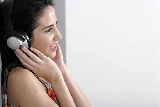Attractive young woman using headphones to listen to music