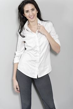 Attractive young woman in white shirt smiling and laughing