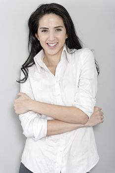 Attractive young woman in white shirt smiling and laughing