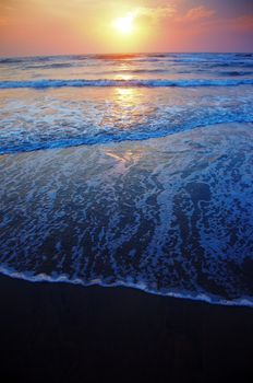 Vertical photo of the sea during sunset. Natural darkness and colors