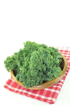 fresh green kale on a napkin in front of light background