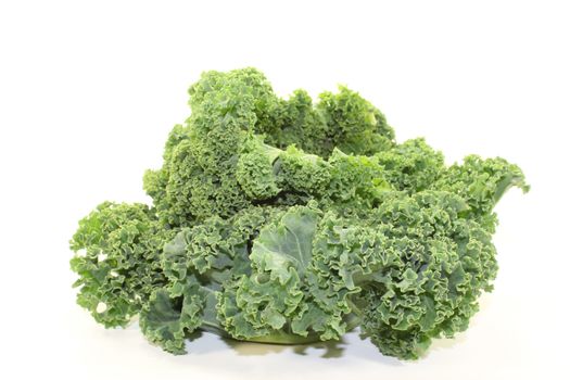 fresh green kale leaves on a white background