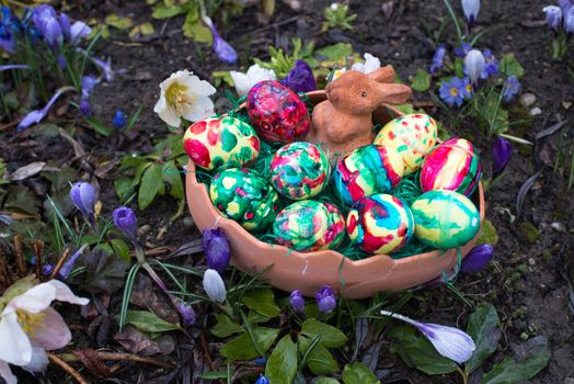 spring crocus flowers and easter basket with easter eggs and bunny decoration