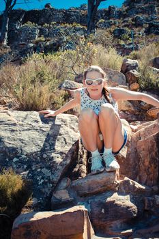 Girl sitting on Rock on Lions Head, Cape Town, South Africa