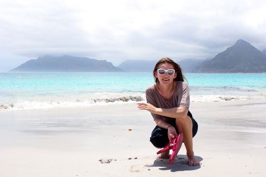 Woman at the Beach of Kommetjie with an upcoming storm in the background