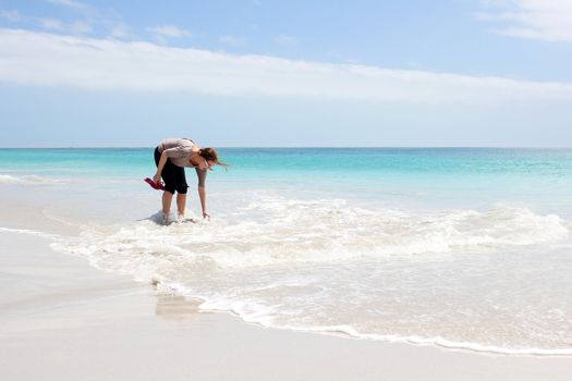 Woman standing in Water at the Beach of Kommetjie