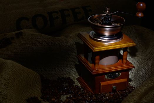 Coffee Mill with beans and burlap. still life