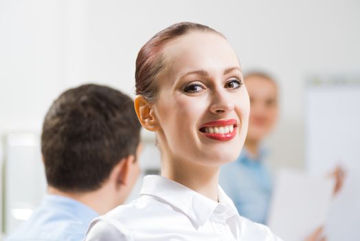 business woman doing a report next presentation boards, listening to her colleagues