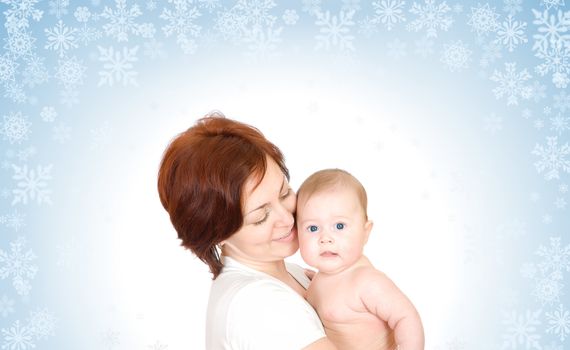 Small baby with mother on snowy background