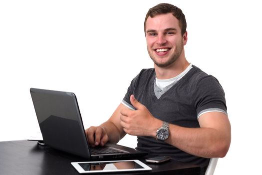 Happy man using pc and smiling while doing thumb up