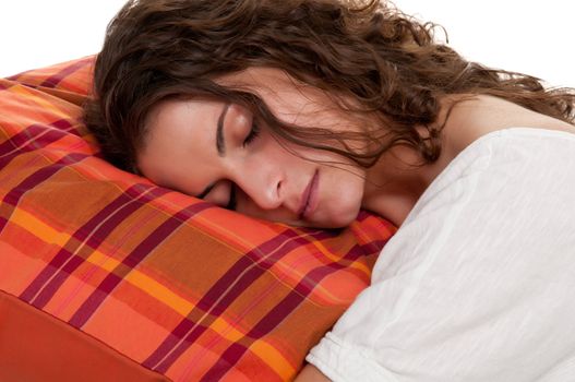 Young woman sleeping on a red pillow, in a white background