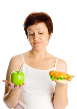 Young woman with hamburger and apple isolated