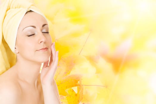 Young woman getting ready for the spa treatment on autumn background