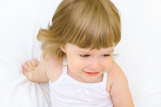 Smiling little girl in a bed